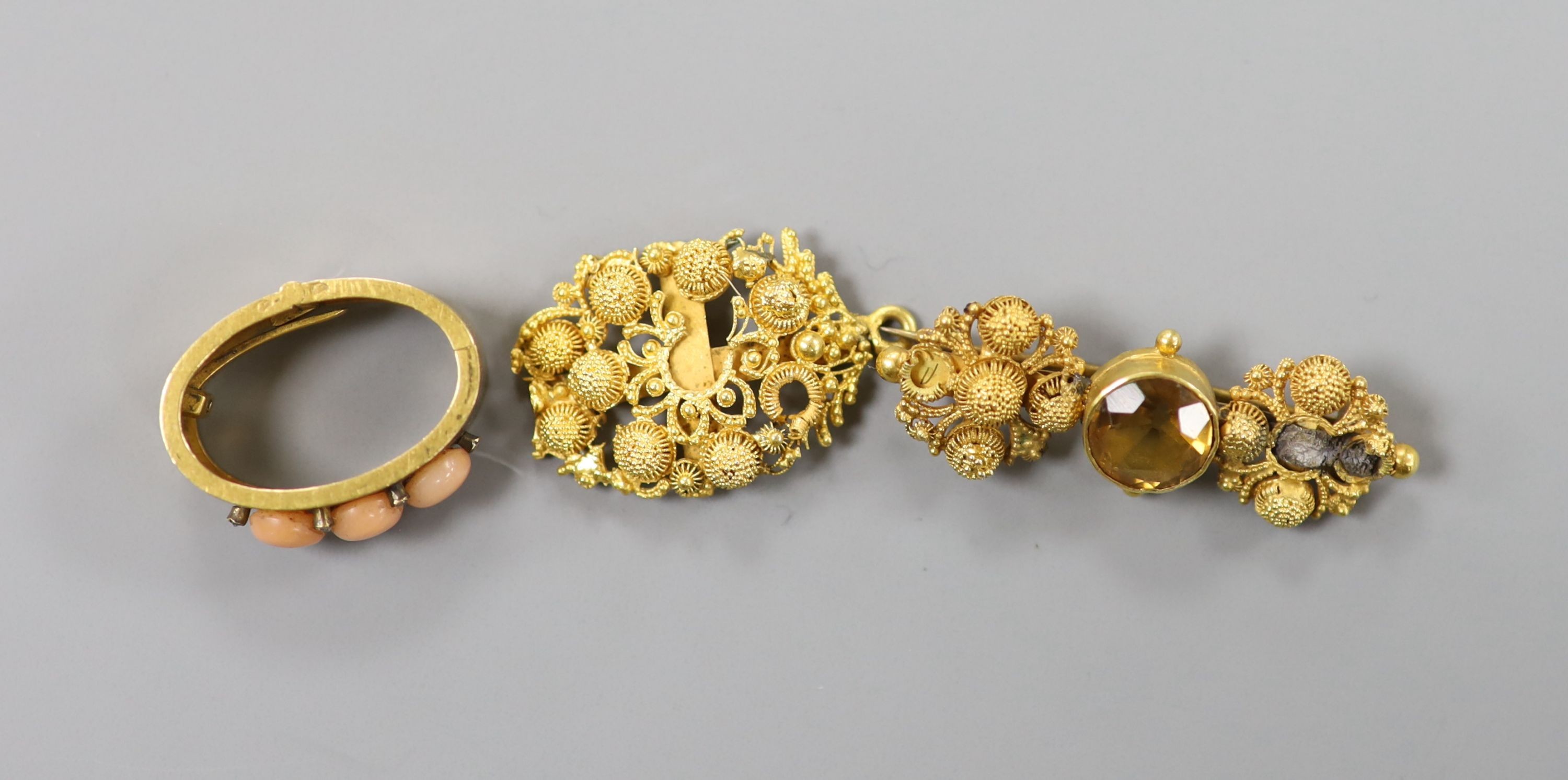 An Edwardian yellow metal, coral and diamond chip set scarf clip, 22mm and two yellow metal filigree items, gross 14.4 grams.